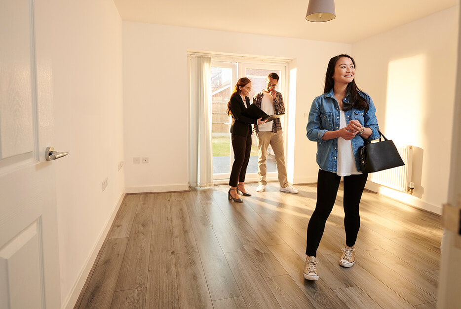 Women standing in an empty room during a home tour