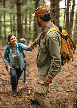 A man helping a woman climb 