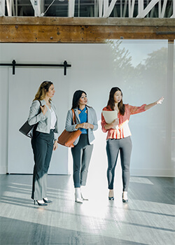 Three women standing in a room 