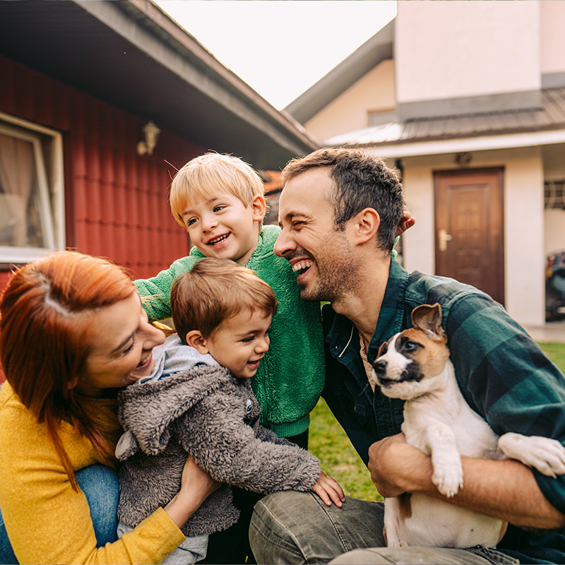 Young family laughing together in their backyard