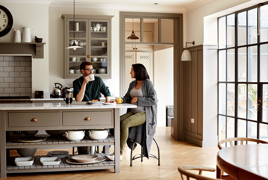 Couple sitting in a kitchen talking