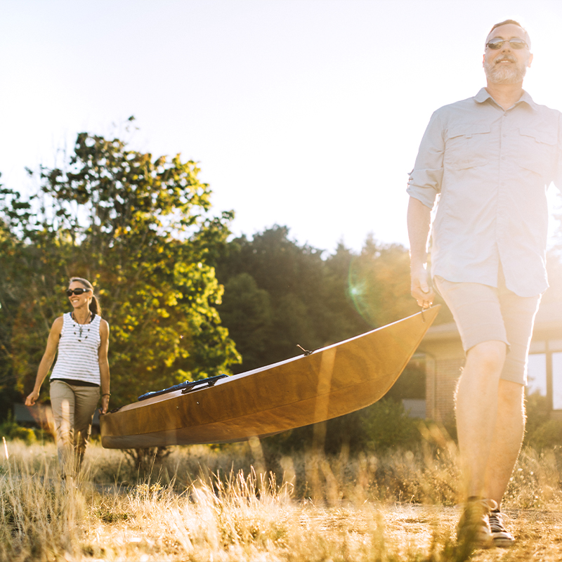 couple carrying canoe together