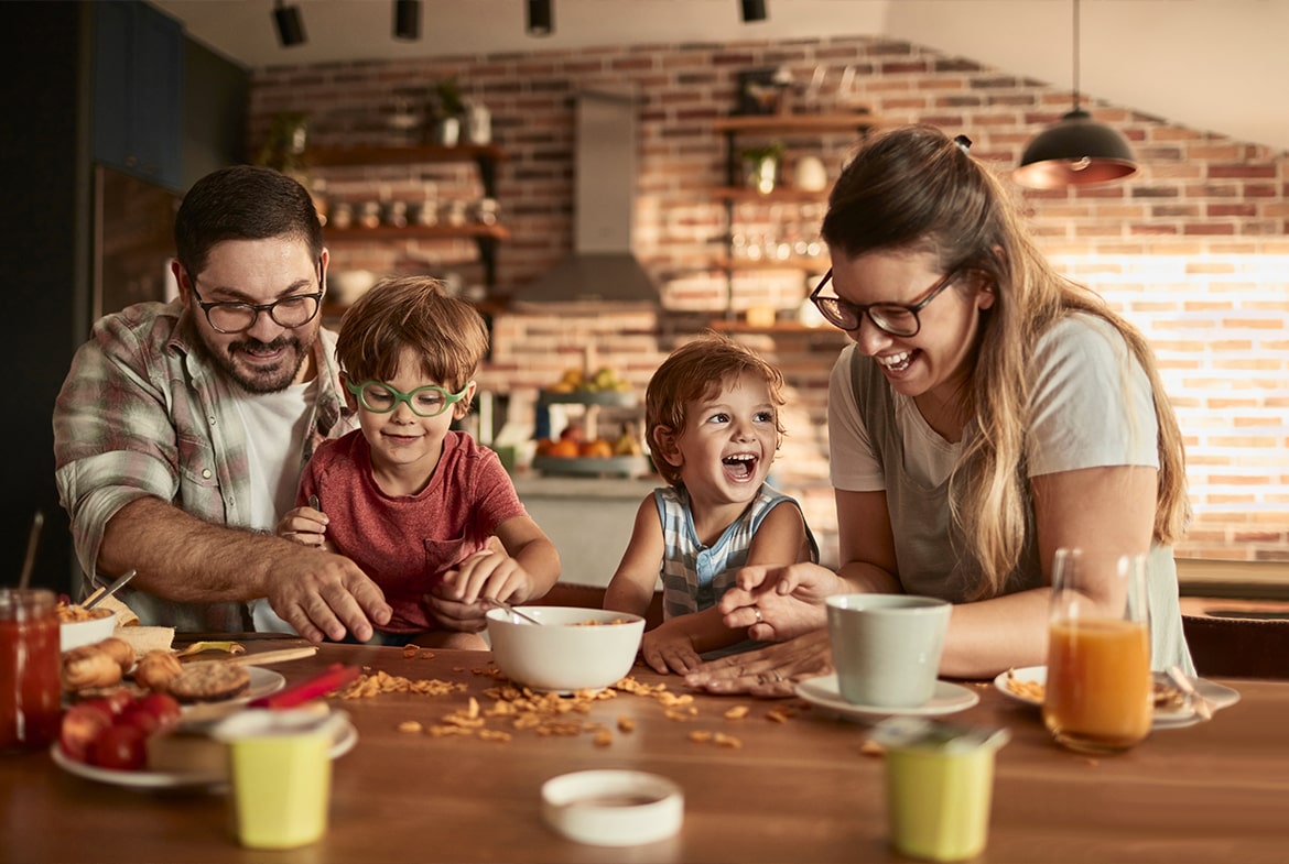 young family eating breakfast together