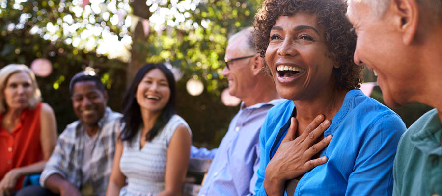 grandmother laughing with her family