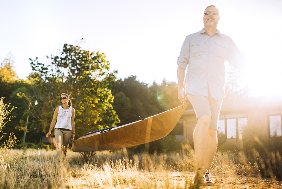 Couple carrying a canoe together