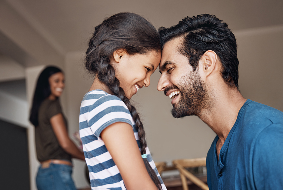 Father and daughter smiling at each other