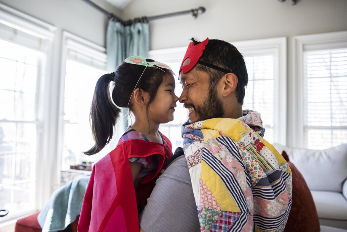 Dad looking at his young daughter smiling