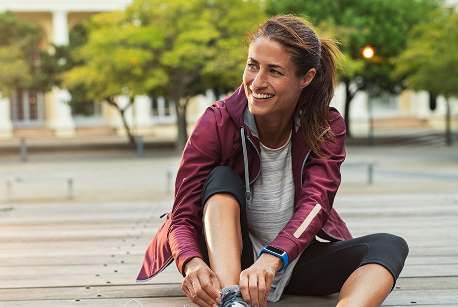 Woman tying her jogging shoes