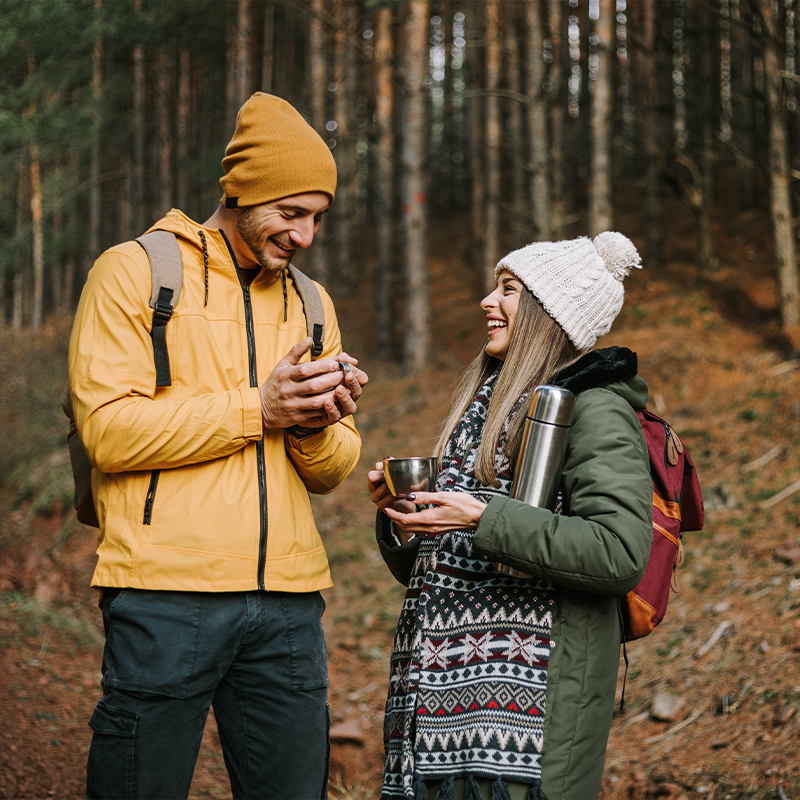 couple enjoying coffee on their hike