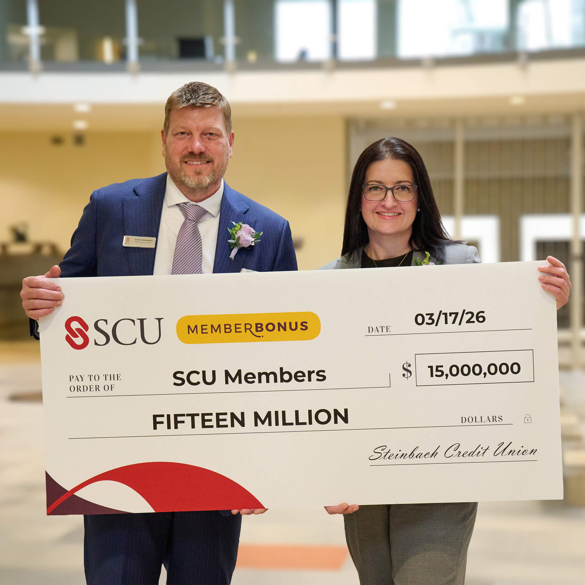 Curtis and Maria holding cheque
