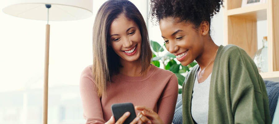 two women looking at a phone