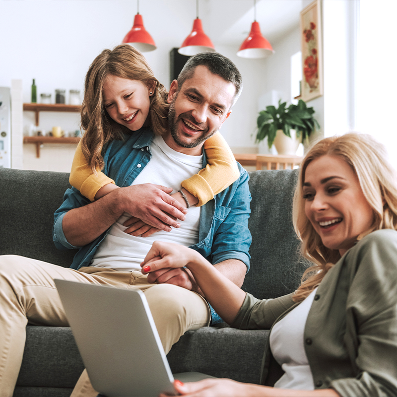 Family sitting on a couch together