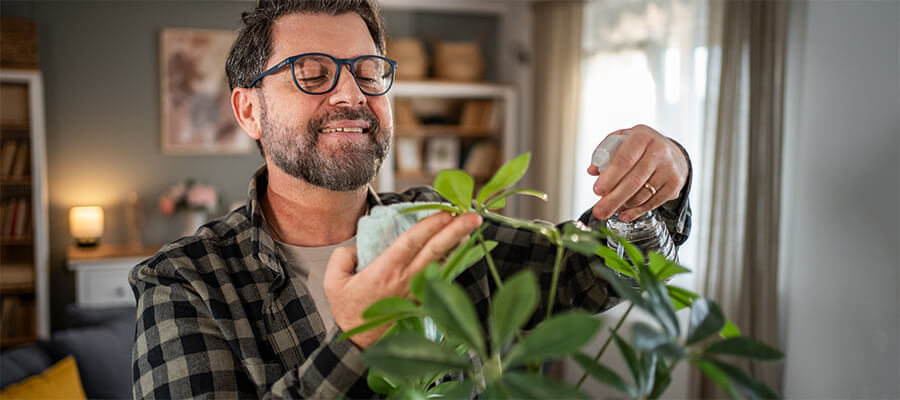 man watering his plants