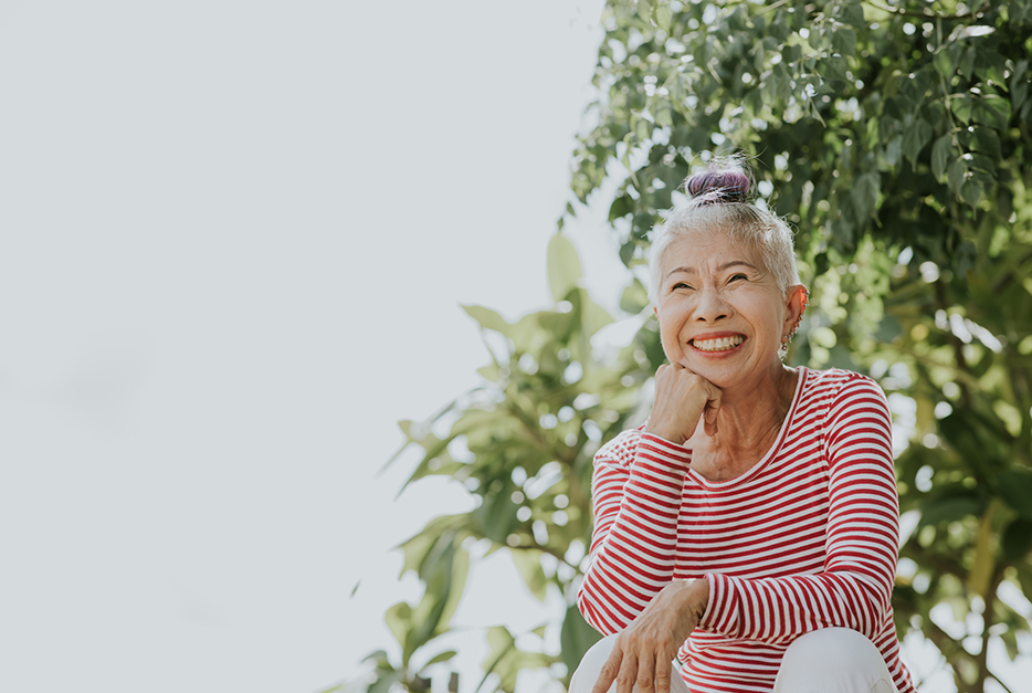 Woman sitting outside smiling