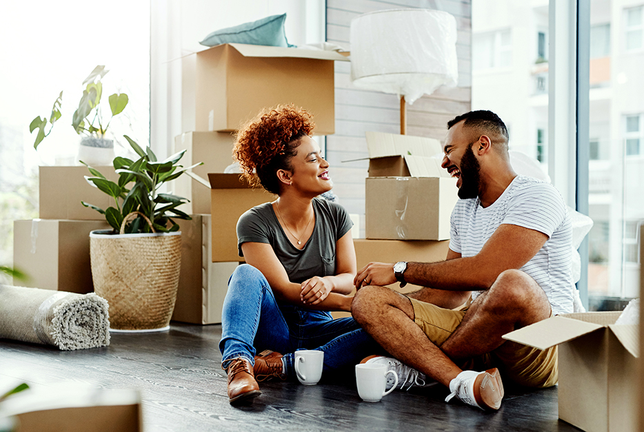 Couple sitting in their home, taking a break from moving