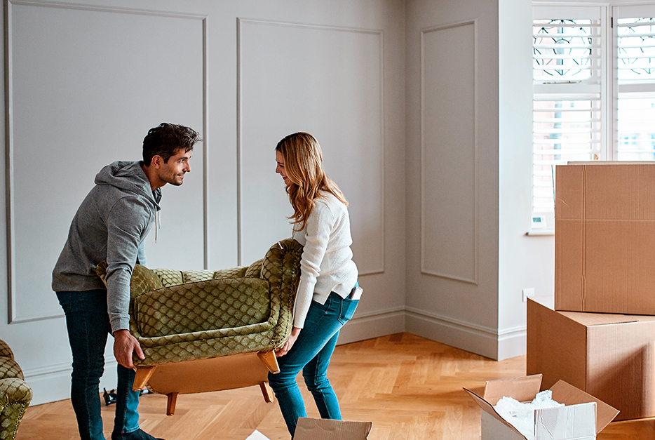 Couple carrying a couch together