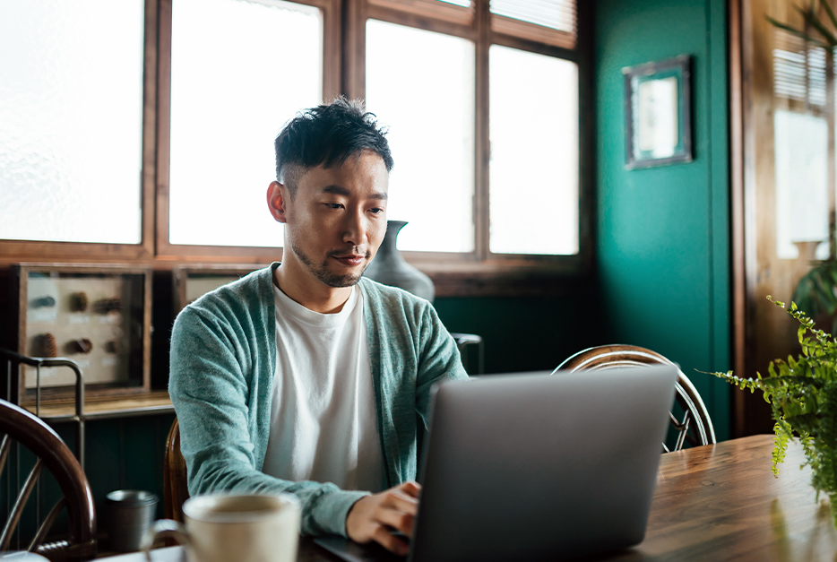 Man typing on his laptop