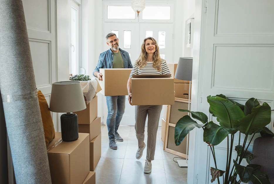 Couple carrying in boxes to their new home