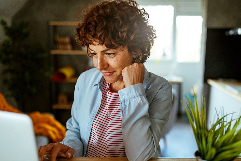 Woman sitting at the table with her laptop