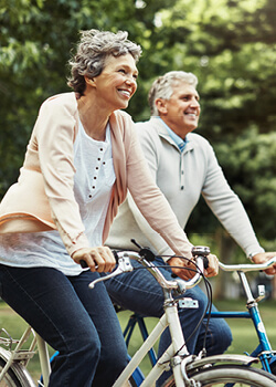 a couple cycling in a park