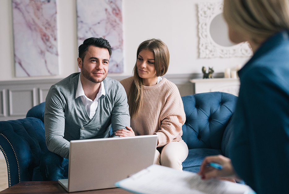 Couple meeting with a wealth advisor with their laptop in front of them