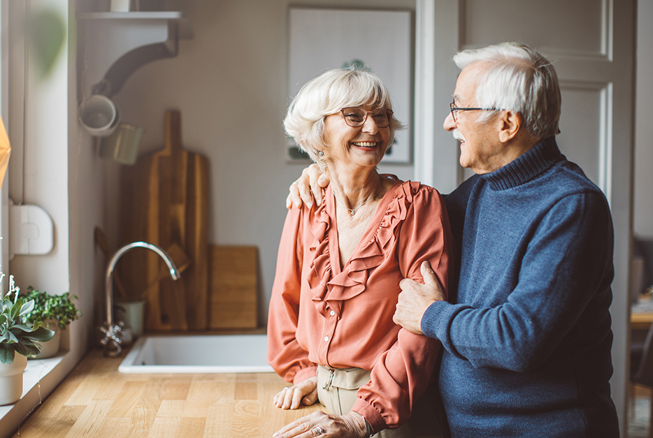 Couple standing in kitchen together