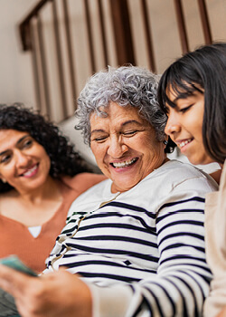 A woman smiling at a picture 