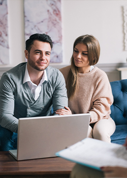 Man and woman working on a laptop