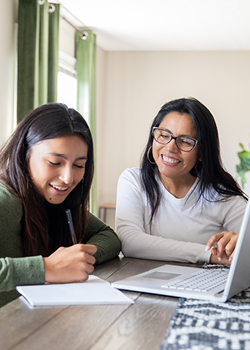 A mom helping her daughter with homework