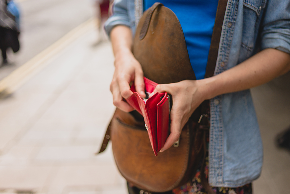 Close up of a person holding their wallet