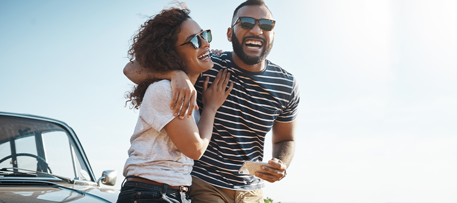 Couple with their arms around each other in the summer