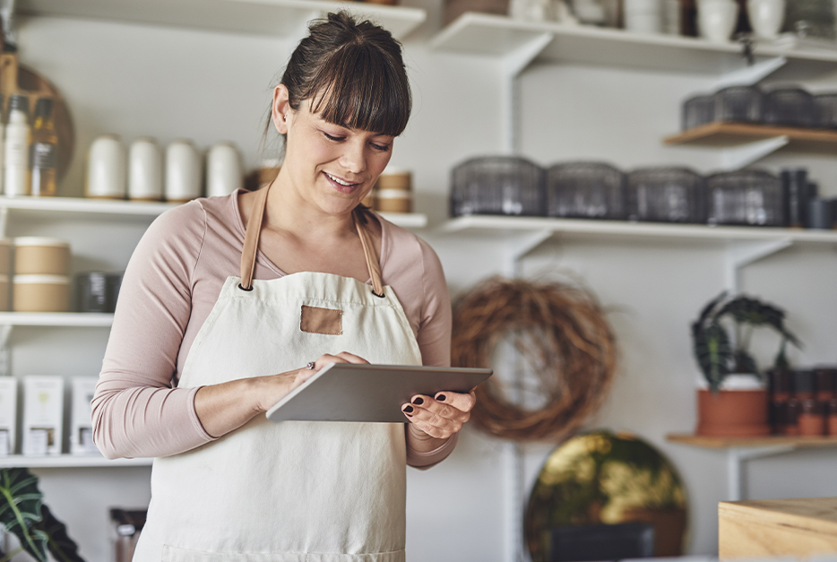 Woman holding a tablet in her bakery