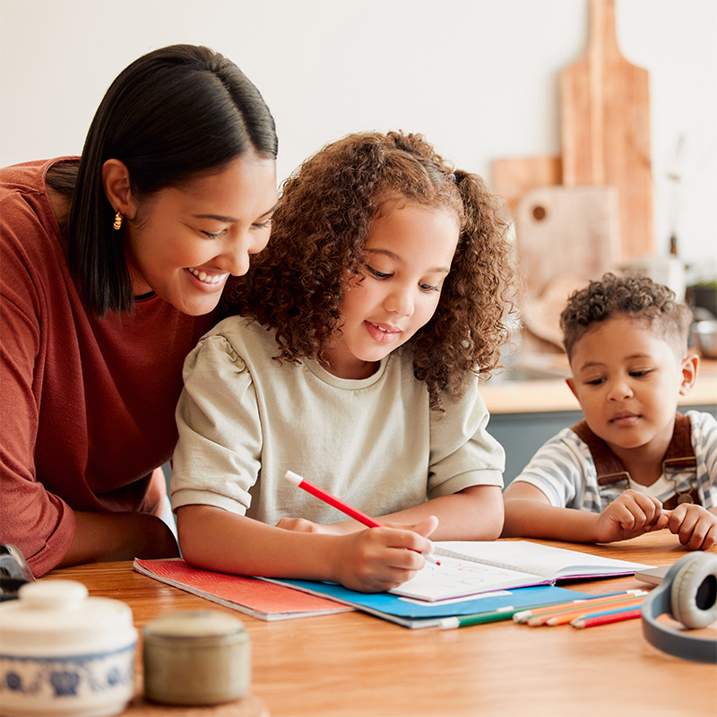 Mother crafting at the table with her daughter and son