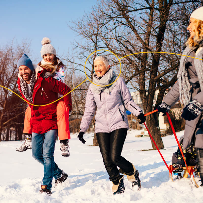 Grandmother walking in the snow with her kids