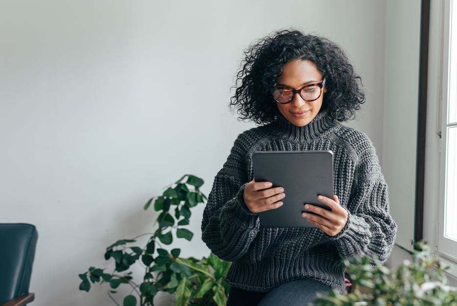 Woman standing and using her tablet