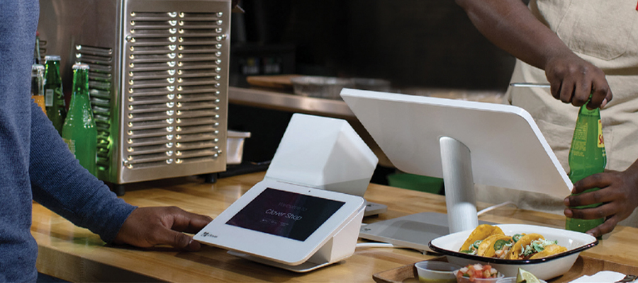 Person paying at a Clover terminal