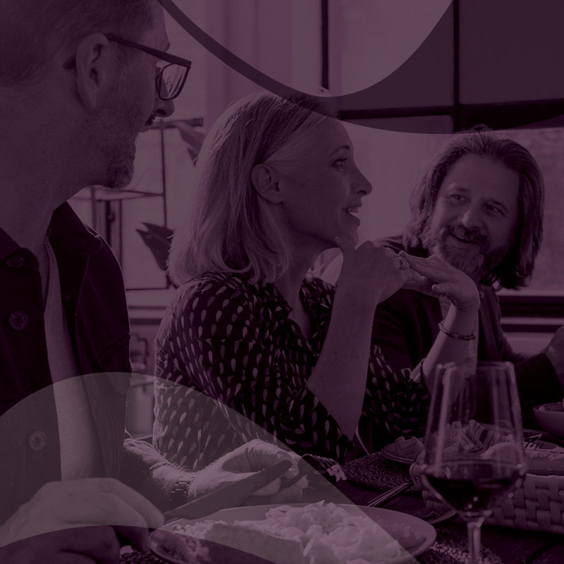 woman talking at a dinner table with friends