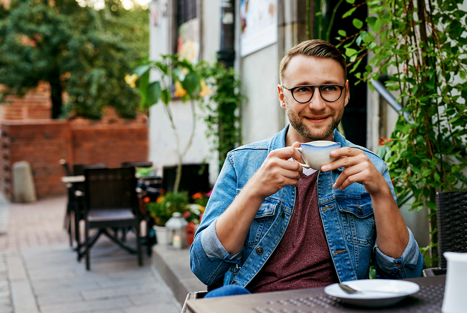 Young man sitting in a cafe with a cup of coffee